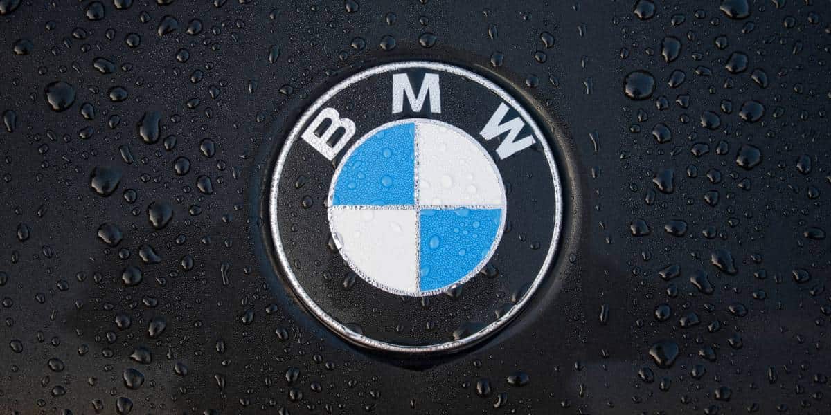 all black BMW Hybrid car in the rain.