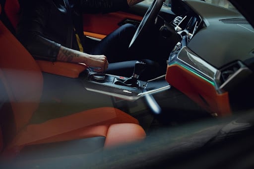 The red and black leather interior of a BMW.