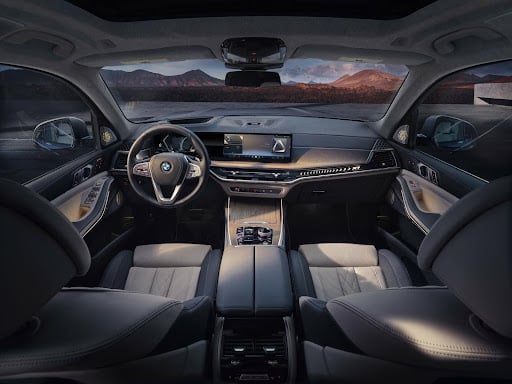 The bmw x7 interior with a mountainous backdrop.