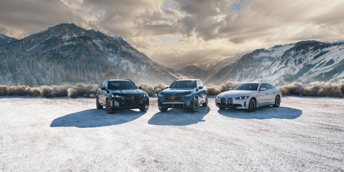 2025 BMW X3 displayed alongside other BMW models in a snowy mountain backdrop, highlighting its luxury SUV appeal.