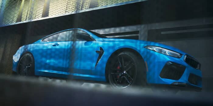 2025 BMW M8 Competition in Frozen Marina Bay Blue, showcasing sleek aerodynamic design and luxury sports car profile.