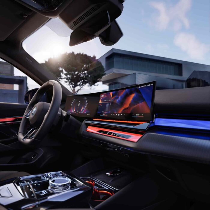 Interior view of BMW i5 M60 featuring a modern dashboard and advanced digital display technology.