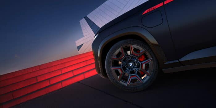 Close-up of BMW wheel and red caliper highlighting BMW Brakes performance design with M details.